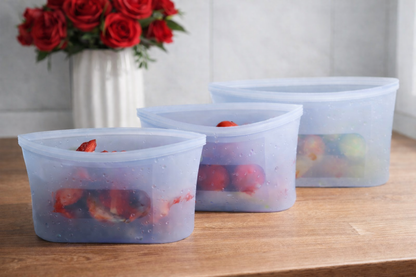 Leakproof silicone food storage bags for fruits and snacks on wooden kitchen surface